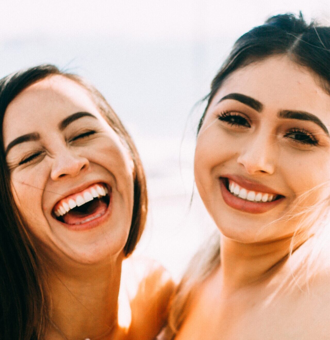 two girls laughing with great teeth